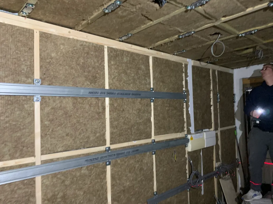Installing wall soundproofing with ceiling prepared for soundproofing too