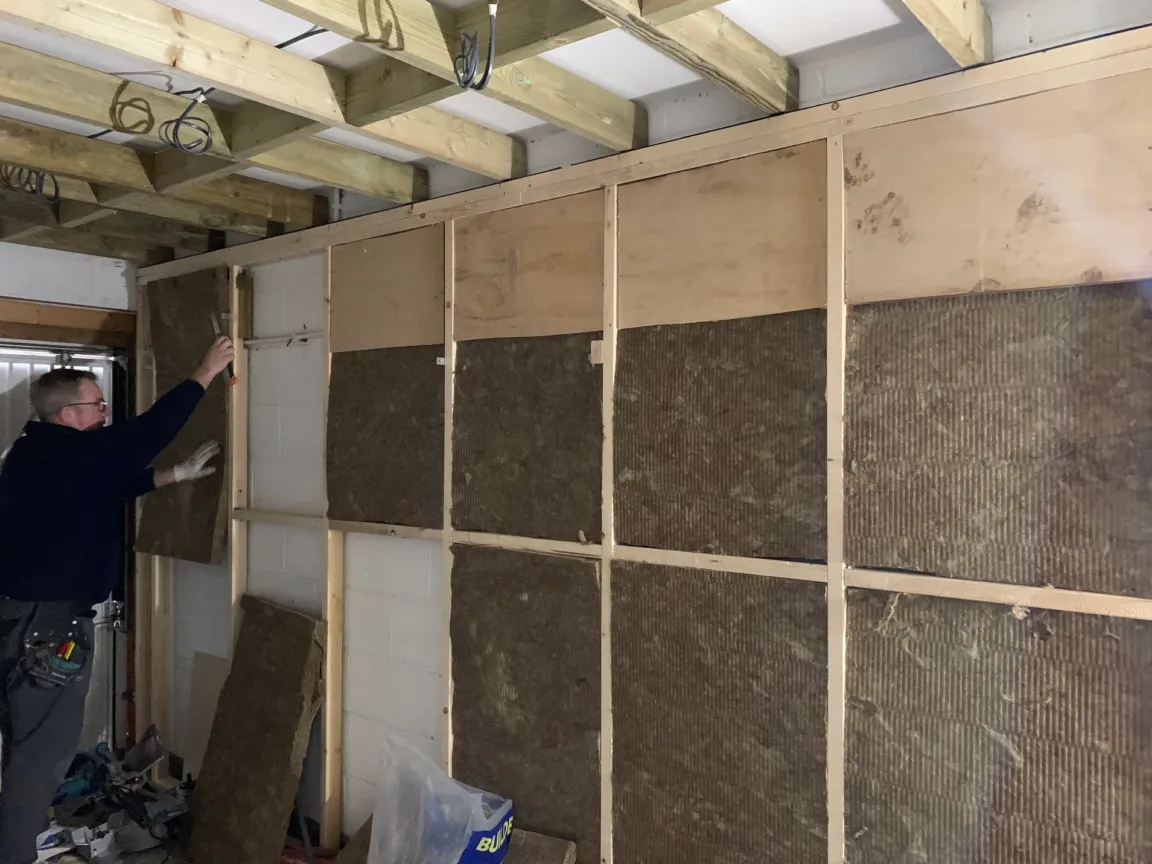 Installing wall soundproofing with ceiling prepared for soundproofing too